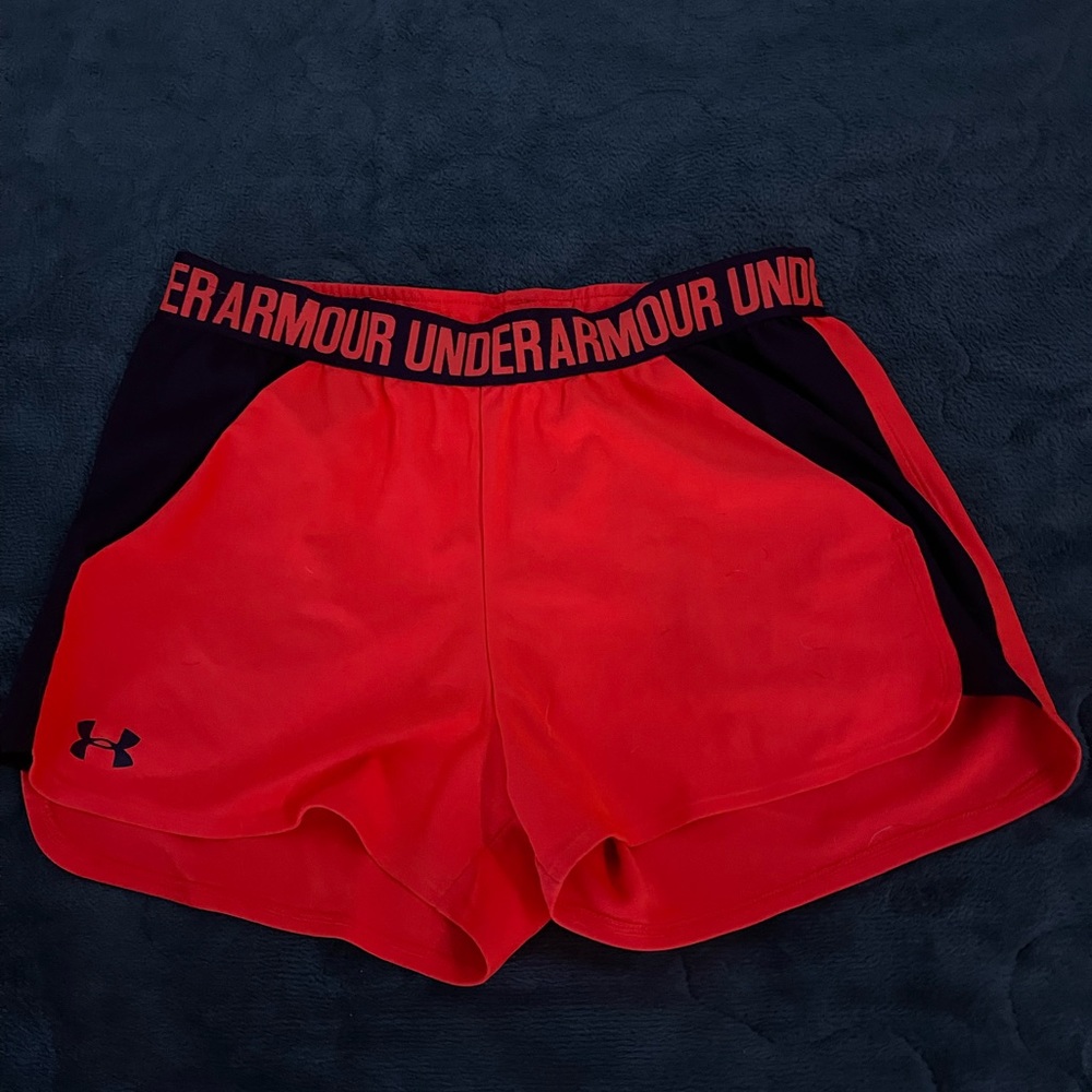 Under Armour. Orange color sunset with some purple. Size medium. Loose fit.